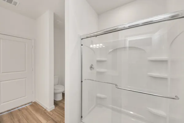 a bathroom with a glass shower door