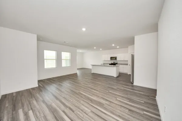 a view of large kitchen with a sink and dishwasher a refrigerator with wooden floor