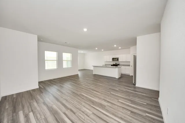a view of large kitchen with a sink and dishwasher a refrigerator with wooden floor