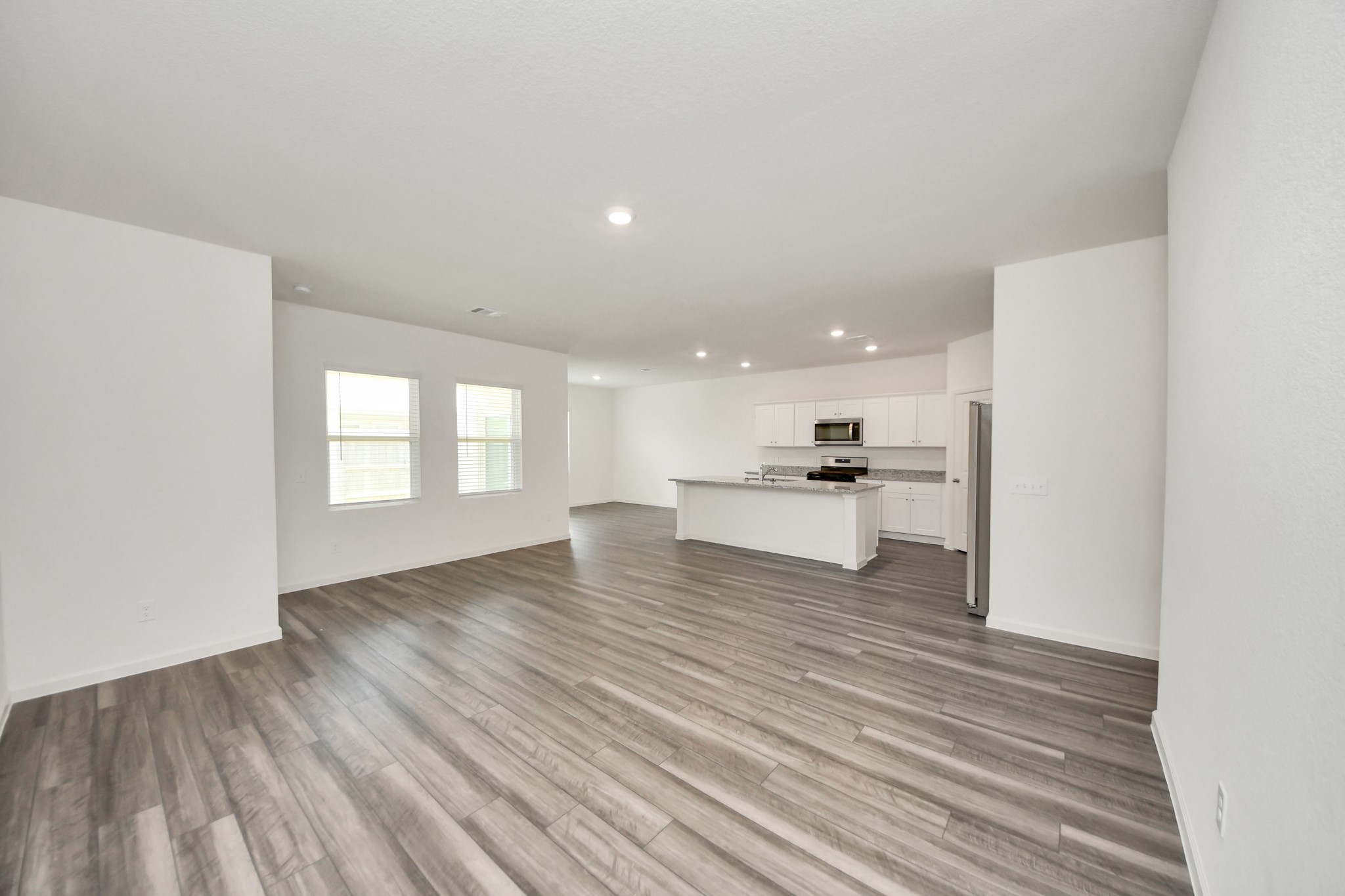 10307 Costa Ter Drive Rosharon, TX 77583 - Photo 7 of 49 a view of large kitchen with a sink and dishwasher a refrigerator with wooden floor