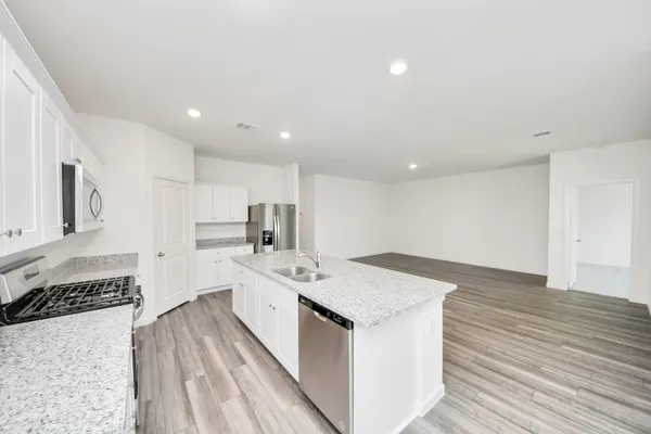 a kitchen with a sink stove and cabinets