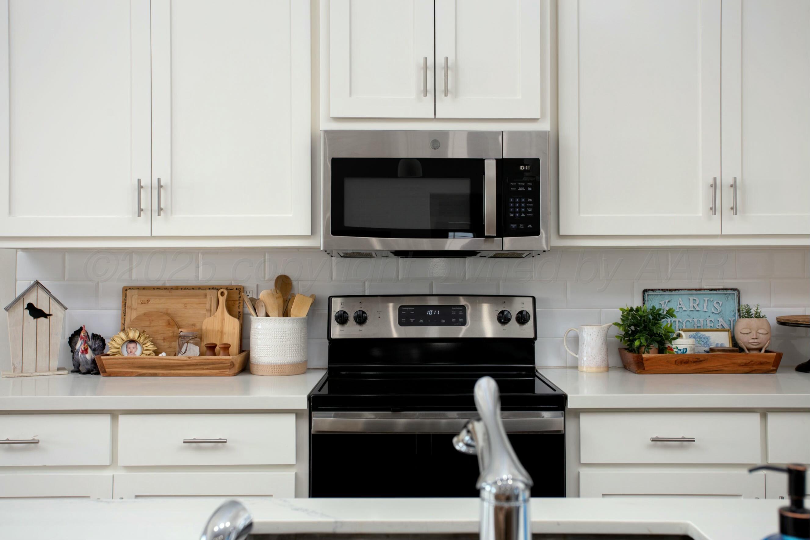 18501 Helium Road Canyon, TX 79015 - Photo 11 of 28 a kitchen with a microwave and cabinets