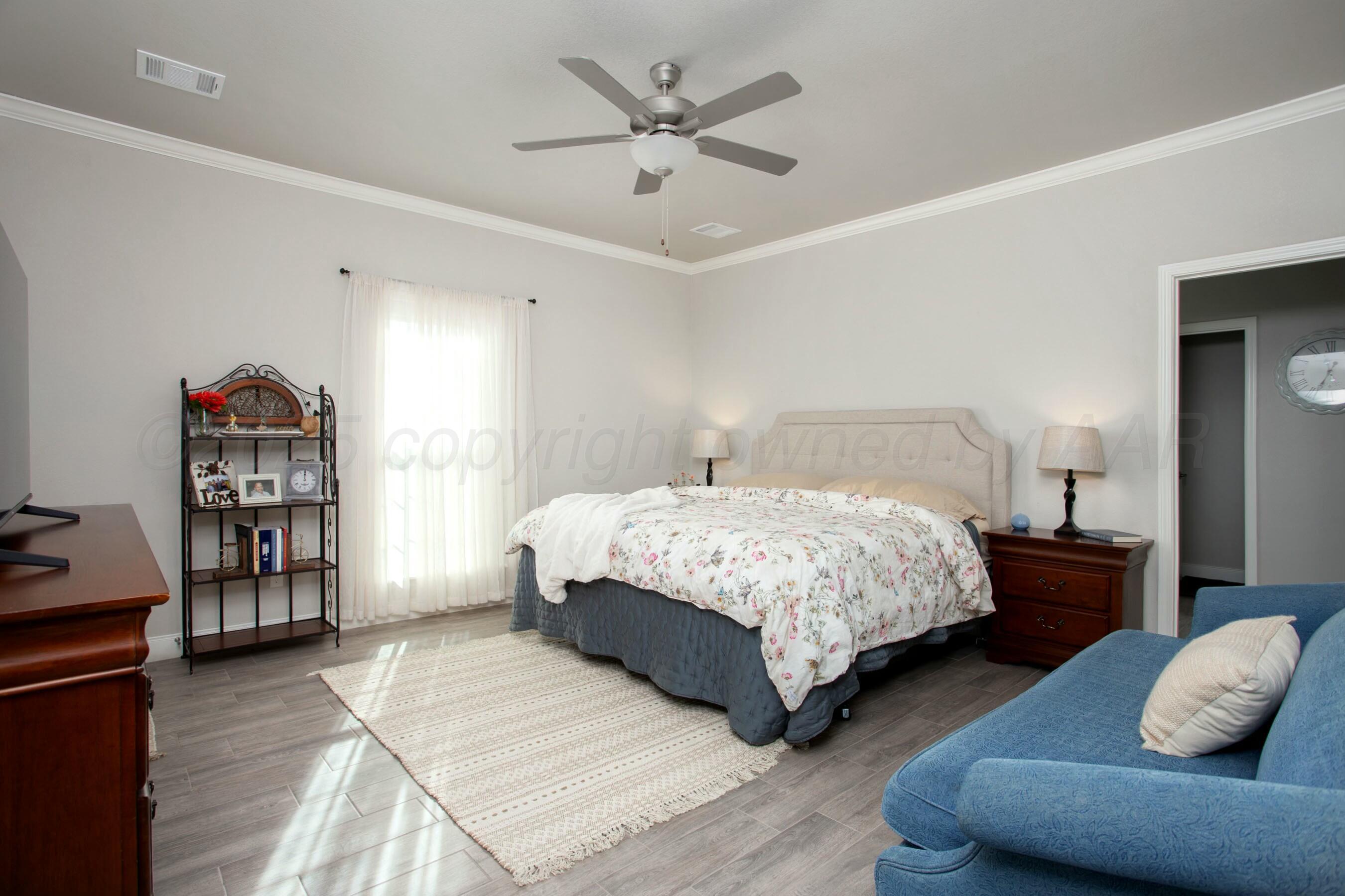 18501 Helium Road Canyon, TX 79015 - Photo 15 of 28 a bedroom with bed and a book shelf