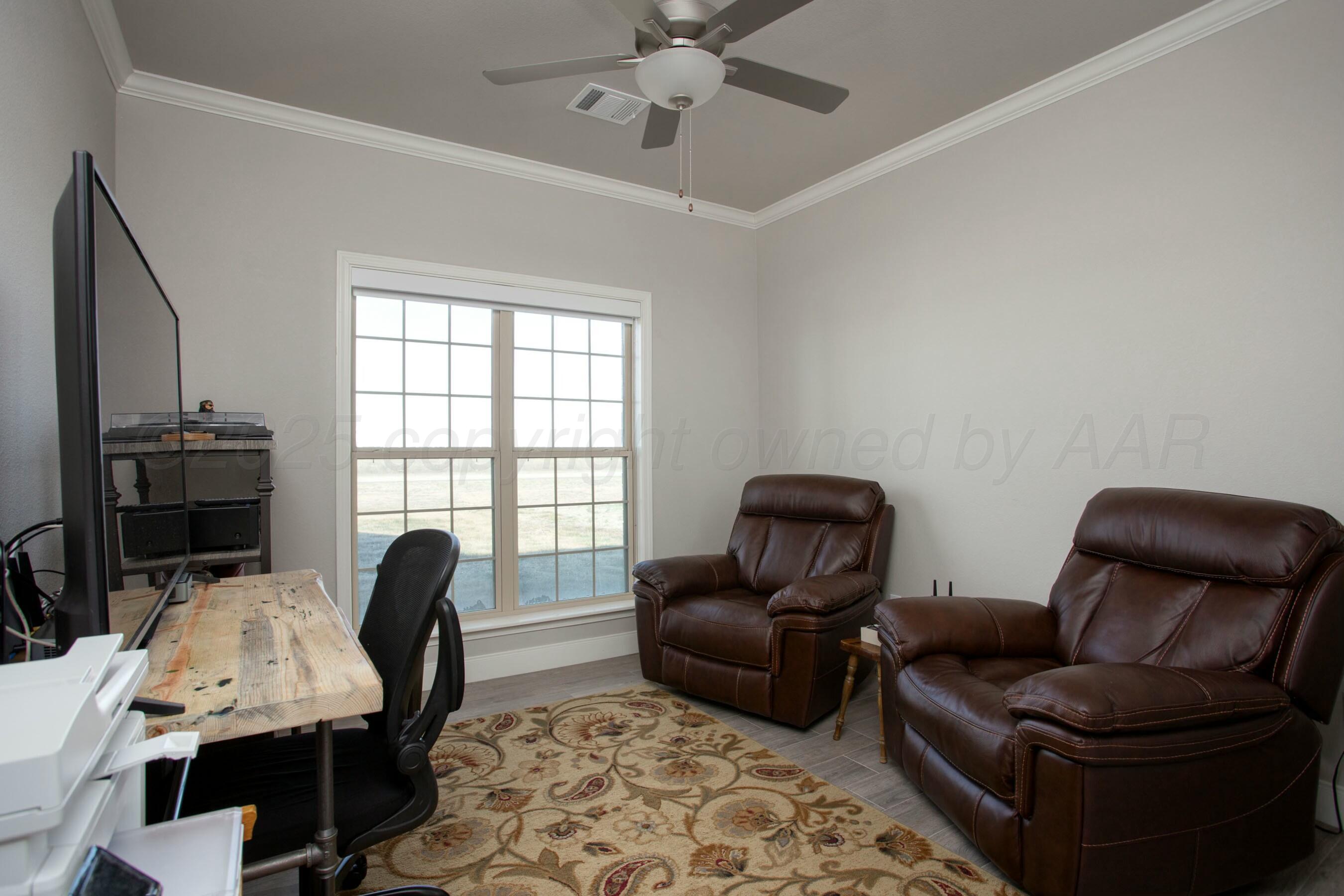 18501 Helium Road Canyon, TX 79015 - Photo 22 of 28 a view of a livingroom with workspace and a couch