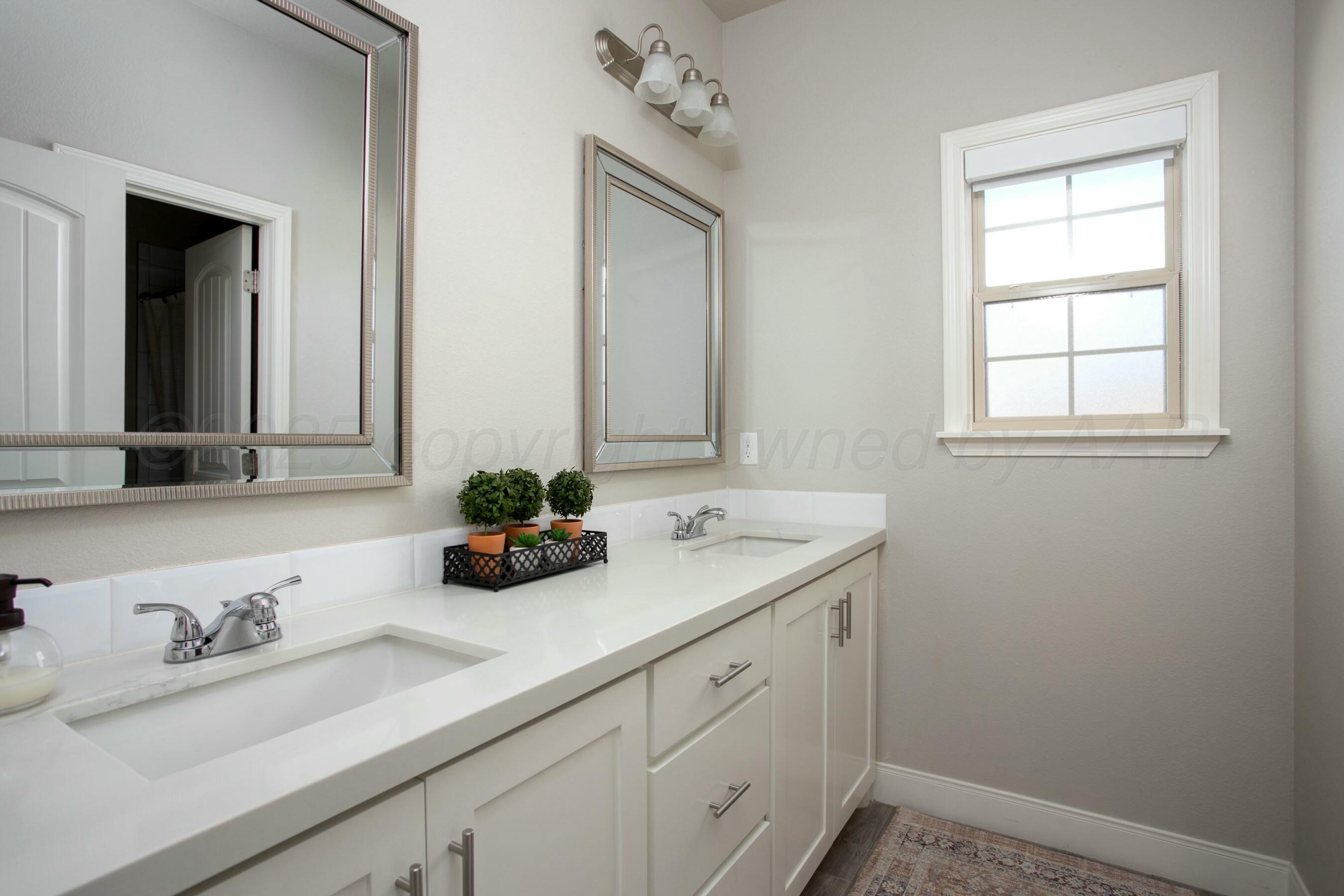 18501 Helium Road Canyon, TX 79015 - Photo 23 of 28 a bathroom with a sink and a mirror