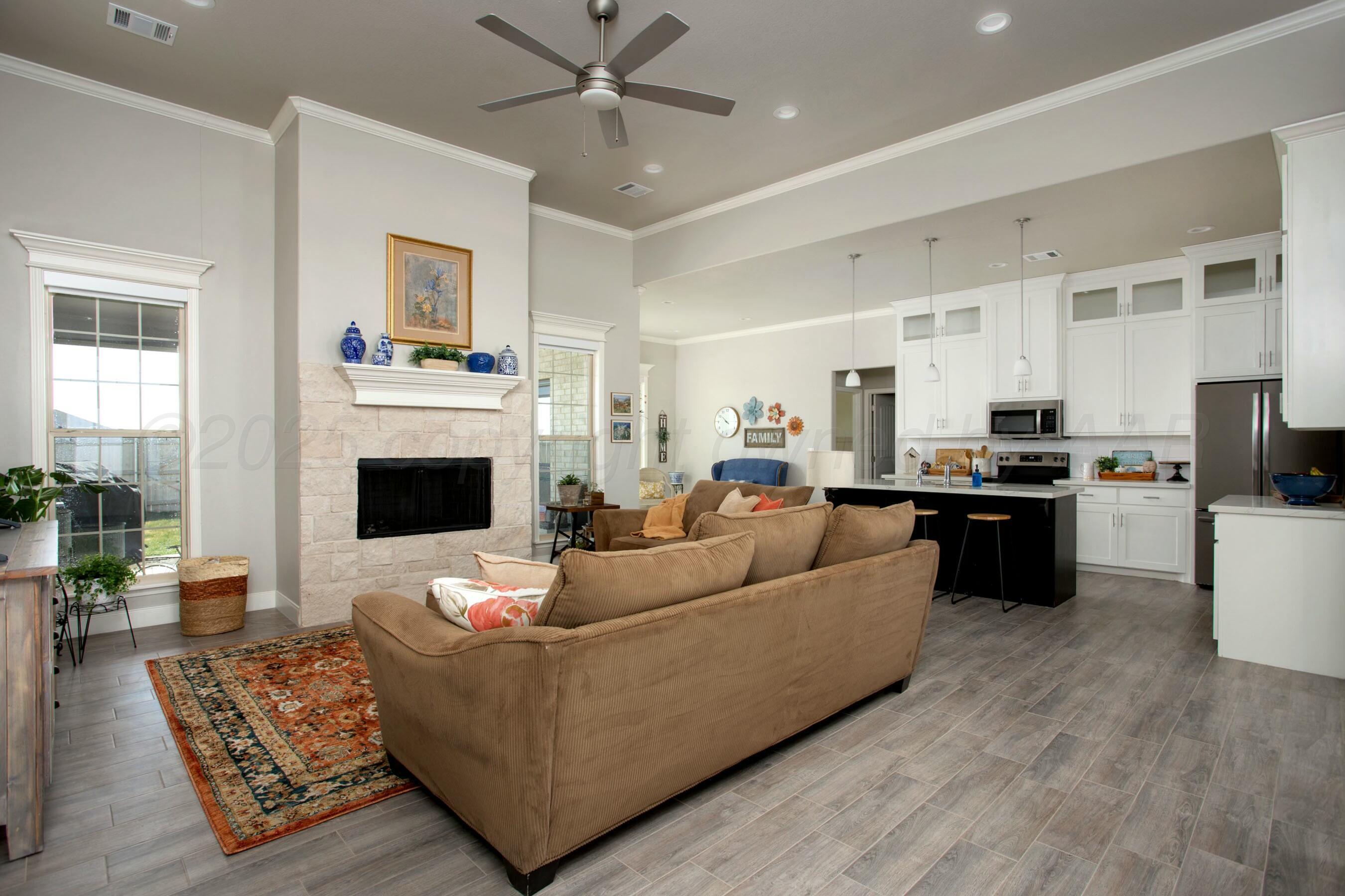 18501 Helium Road Canyon, TX 79015 - Photo 4 of 28 a living room with furniture and a fireplace