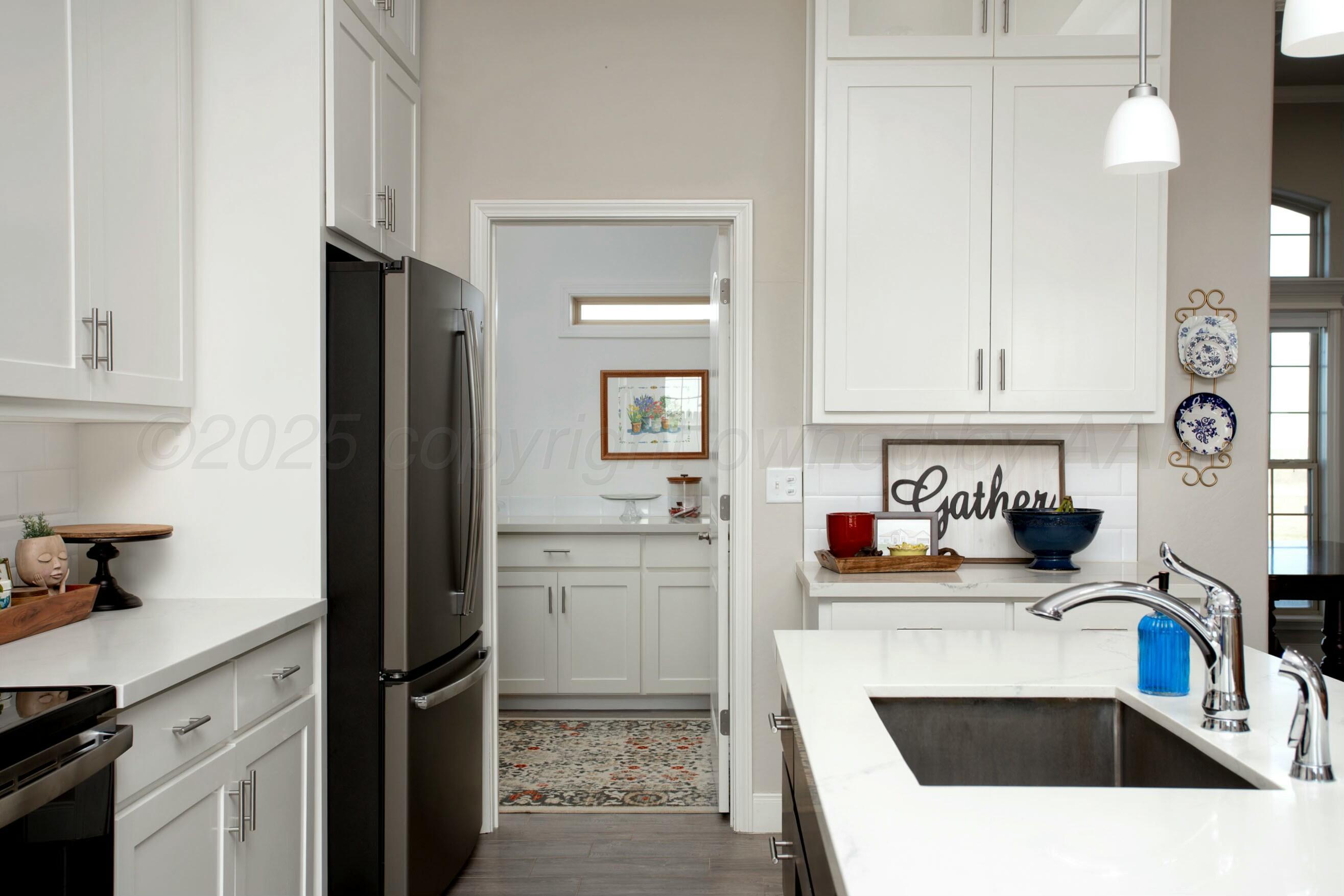 18501 Helium Road Canyon, TX 79015 - Photo 10 of 28 a kitchen with granite countertop a sink stove and refrigerator