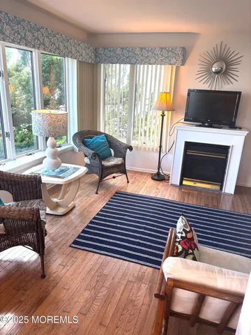 a view of a dining room with furniture wooden floor and a chandelier