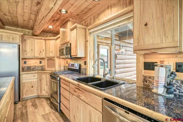 a kitchen with stainless steel appliances granite countertop a stove and a microwave
