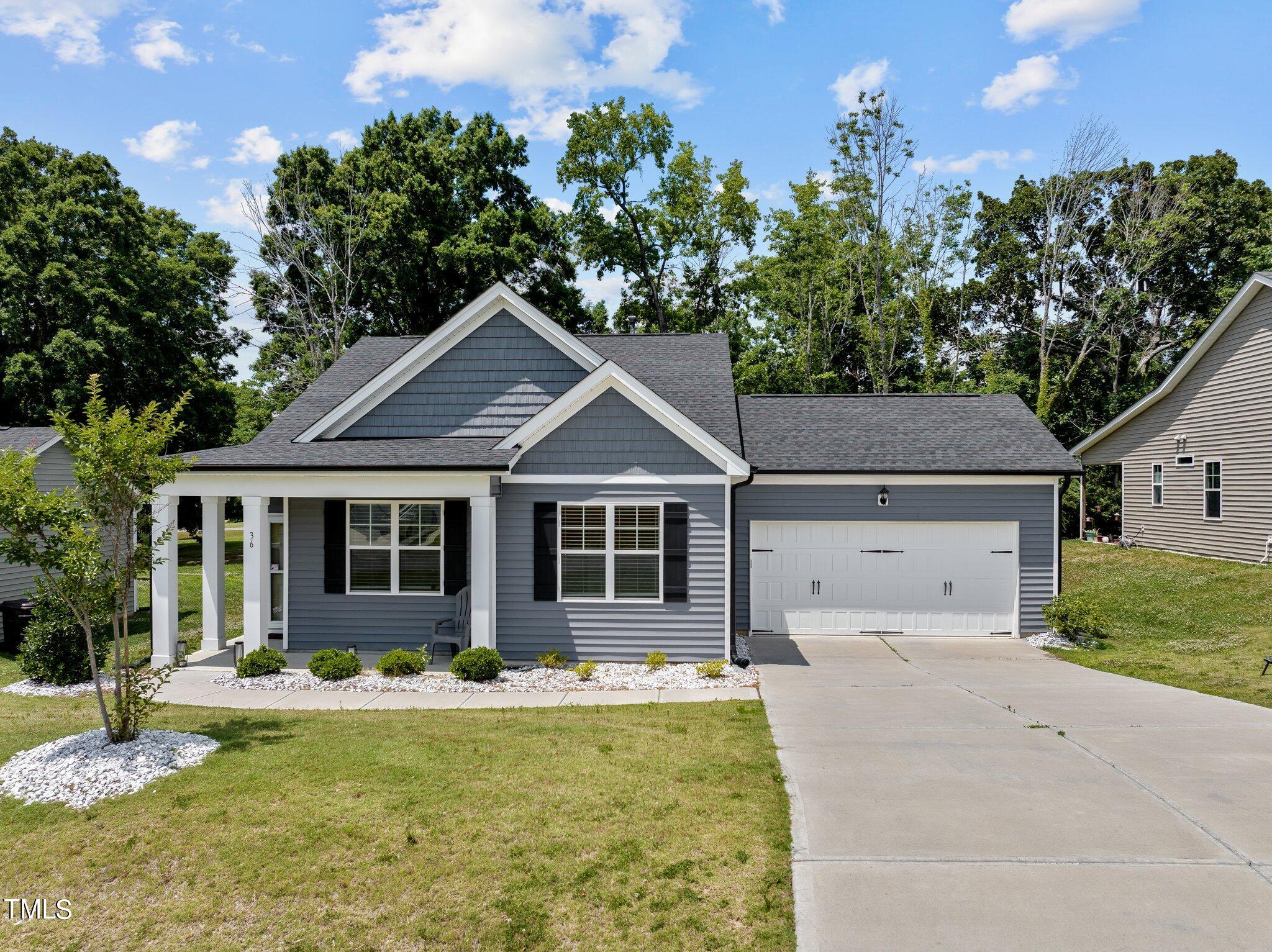 36 Mae Court Roxboro, NC 27573 - Photo 1 of 34 a front view of a house with swimming pool and porch
