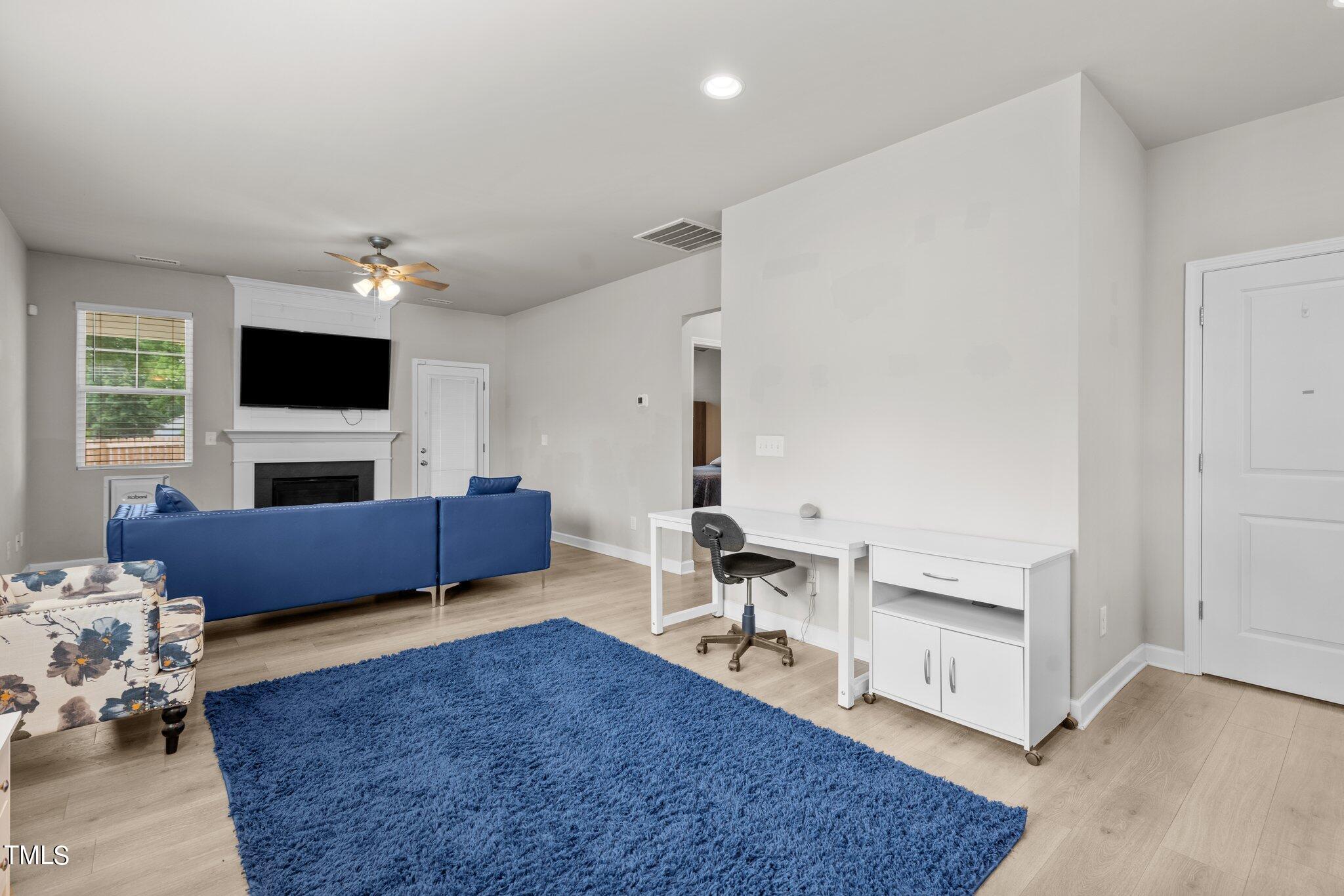 36 Mae Court Roxboro, NC 27573 - Photo 10 of 34 a living room with furniture a fireplace and a flat screen tv