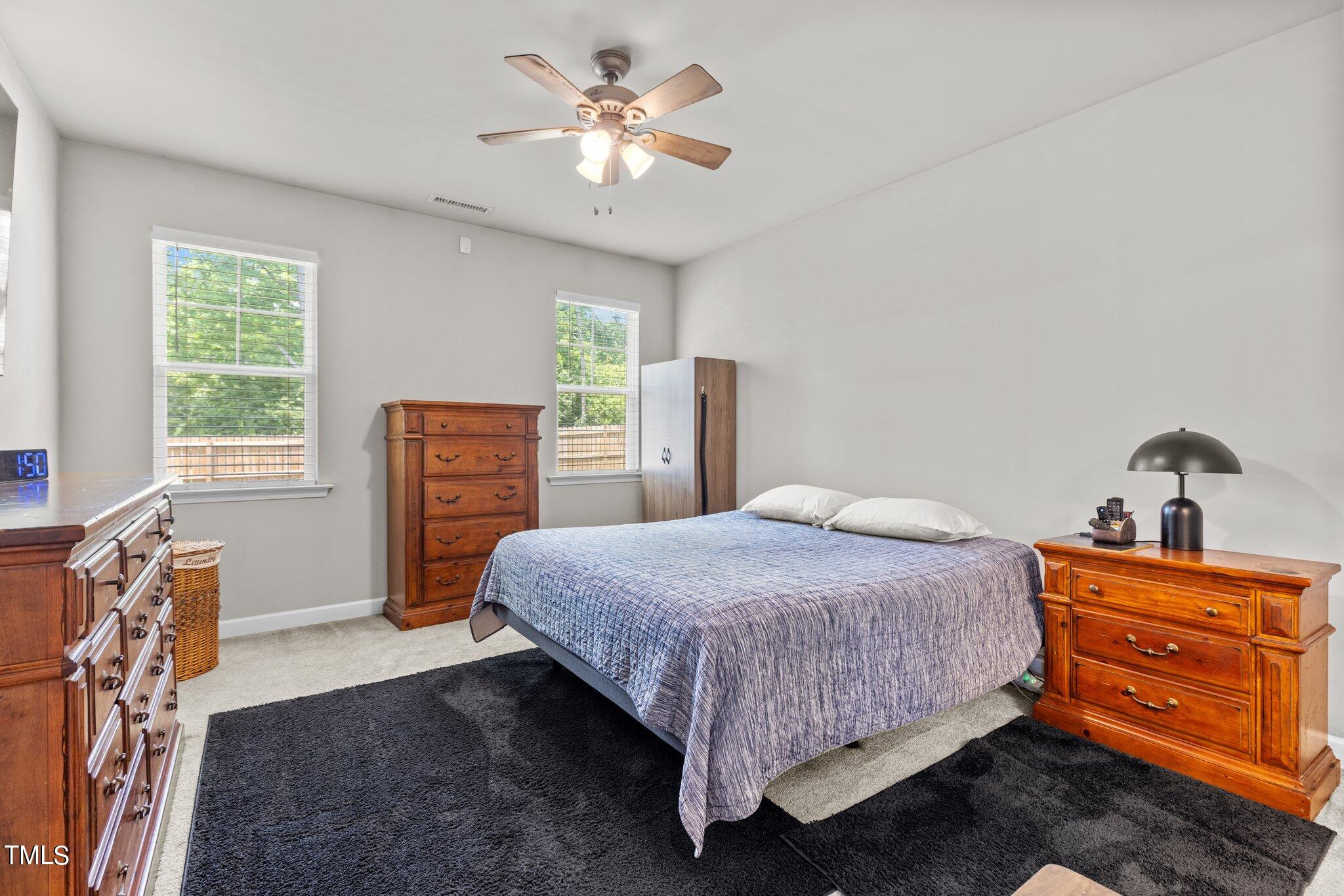 36 Mae Court Roxboro, NC 27573 - Photo 16 of 34 a bedroom with a bed and a dresser next to a window