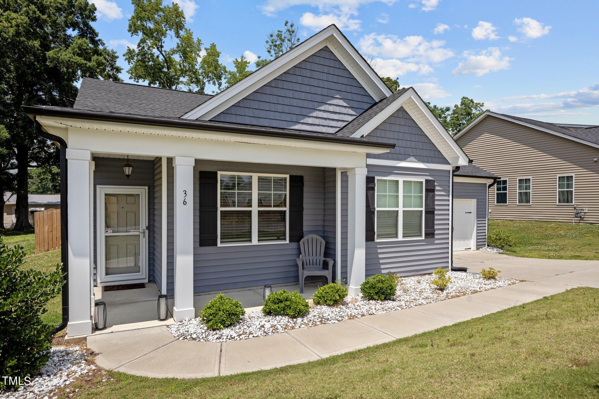 36 Mae Court Roxboro, NC 27573 - Photo 2 of 34 a front view of a house with a yard and outdoor seating