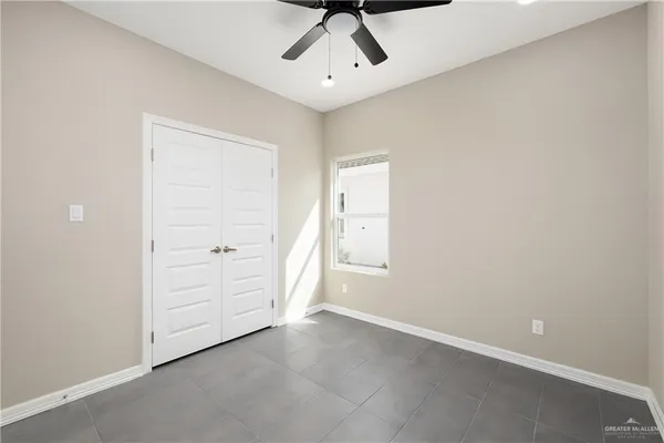 an empty room with closet and cabinet