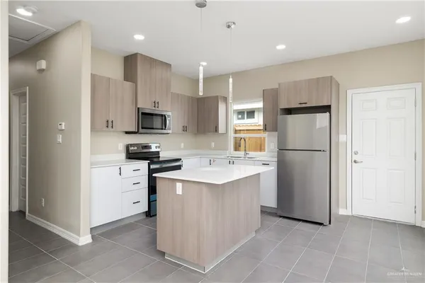a kitchen with cabinets and stainless steel appliances