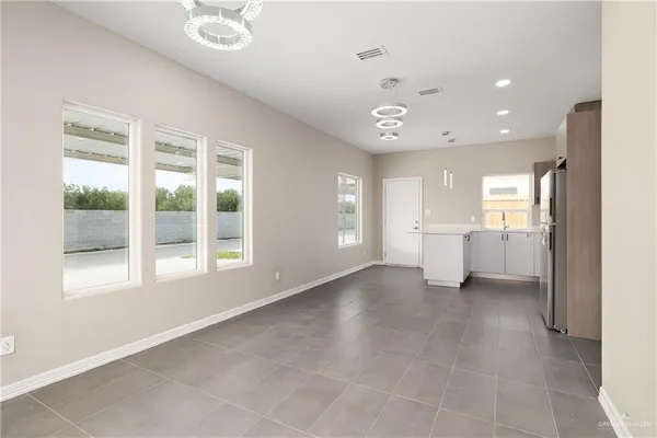 a view of a kitchen with a refrigerator and a window