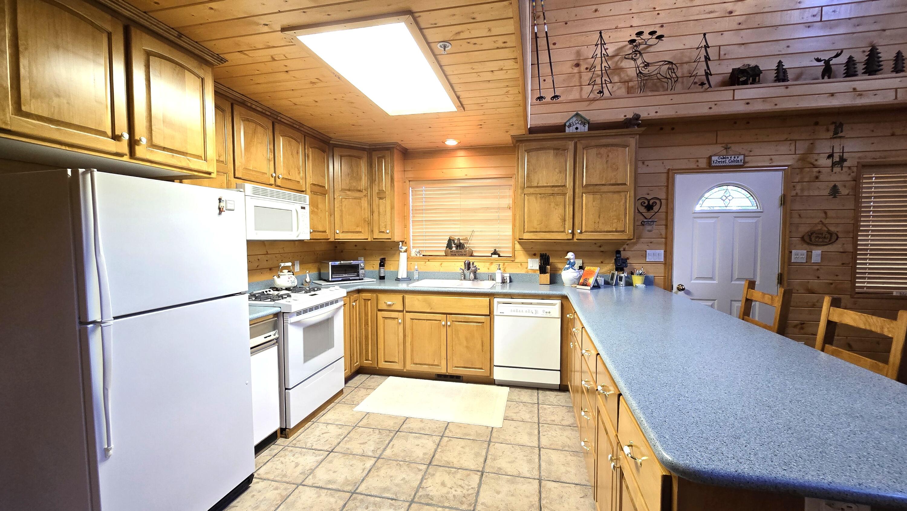650 South Ridge Point Drive Panguitch, UT 84759 - Photo 4 of 38 Kitchen View 1 Propane stove, maple cabinets, spacious counter for prep or extra seating, D/W, T/C