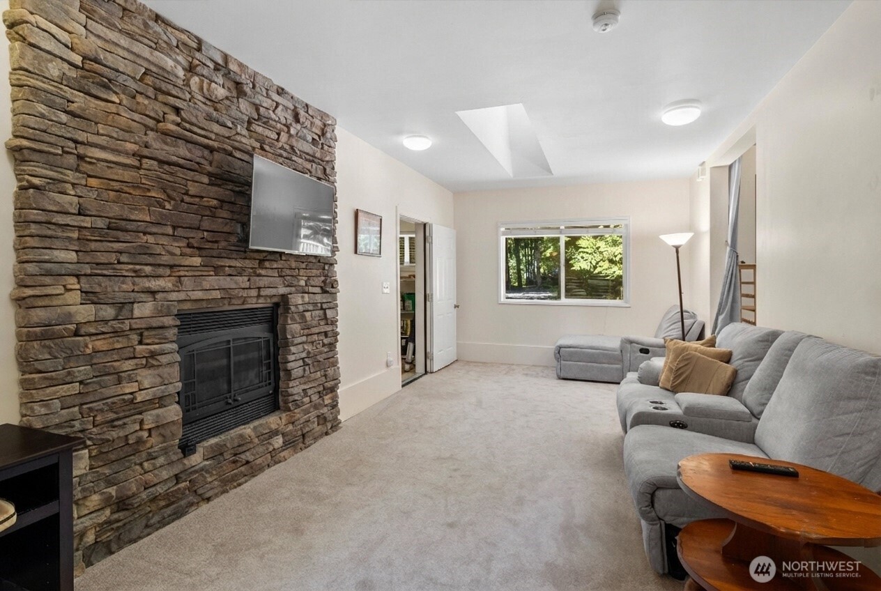 7036 Rainier Way Glacier, WA 98244 - Photo 13 of 31 a living room with furniture a flat screen tv and a fireplace