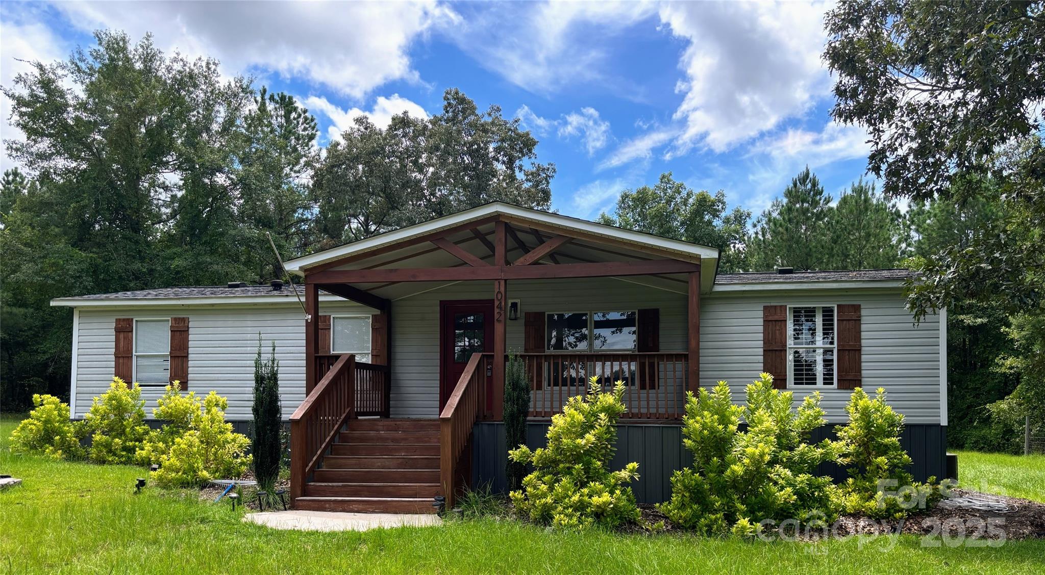 a front view of a house with garden