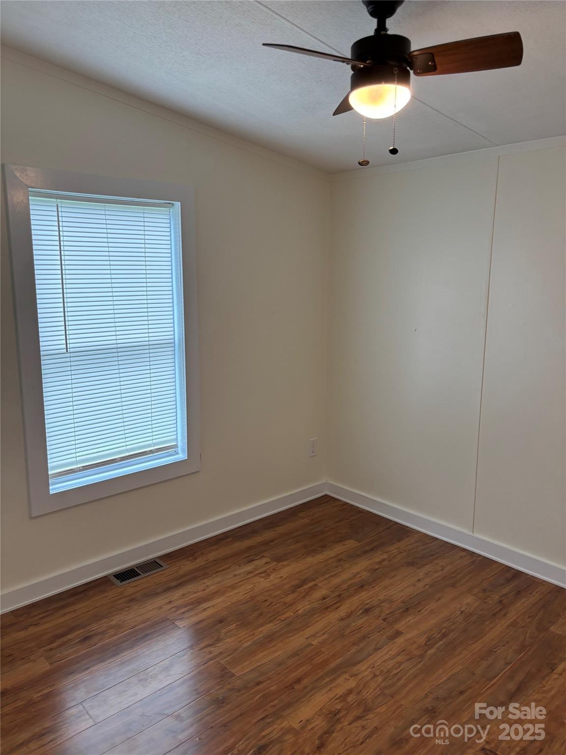 1042 Bart Thurman Road Mount Croghan, SC 29727 - Photo 13 of 16 an empty room with wooden floor and windows