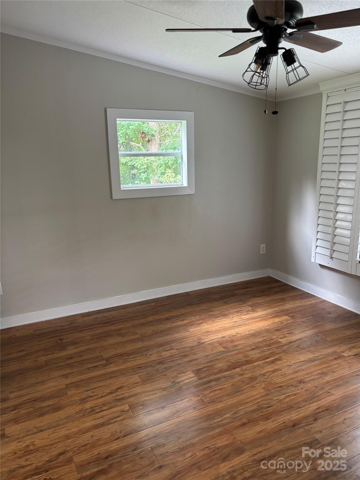 1042 Bart Thurman Road Mount Croghan, SC 29727 - Photo 15 of 16 a view of an empty room with wooden floor ceiling fan and windows