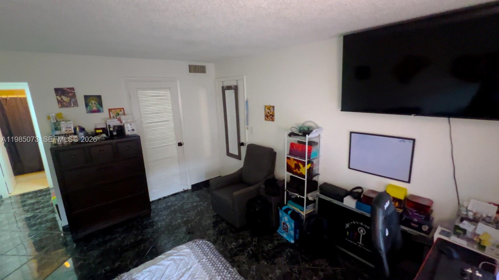 1900 West 68th Street, Unit D207 Hialeah, FL 33014 - Photo 6 of 33 a room with furniture and a flat screen tv