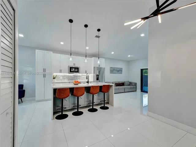 a large kitchen with a table and chairs