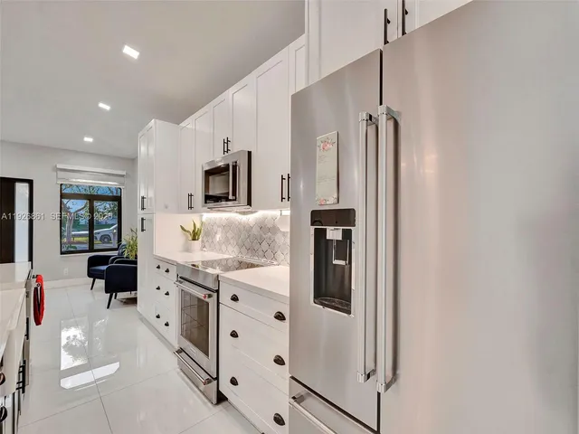 a kitchen with stainless steel appliances a refrigerator sink and stove