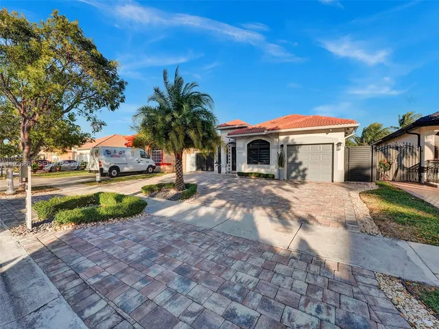 a view of house with outdoor space and parking