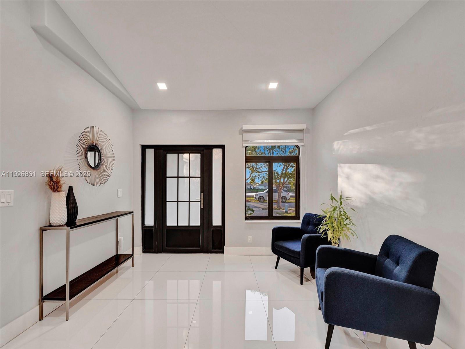 19901 Northwest 77th Court Hialeah, FL 33015 - Photo 21 of 50 a living room with furniture and a window