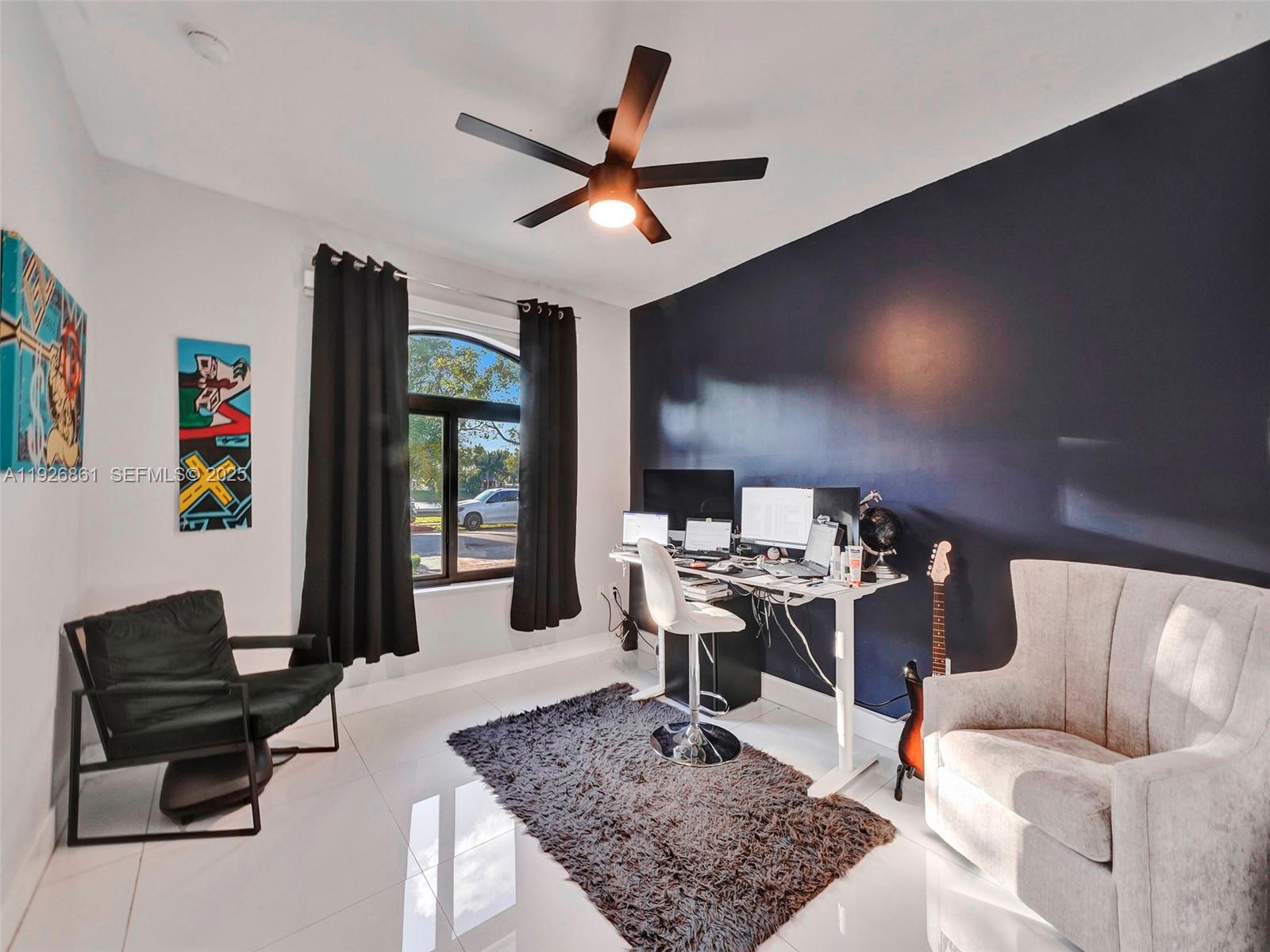 19901 Northwest 77th Court Hialeah, FL 33015 - Photo 22 of 50 a living room with furniture a rug and a flat screen tv