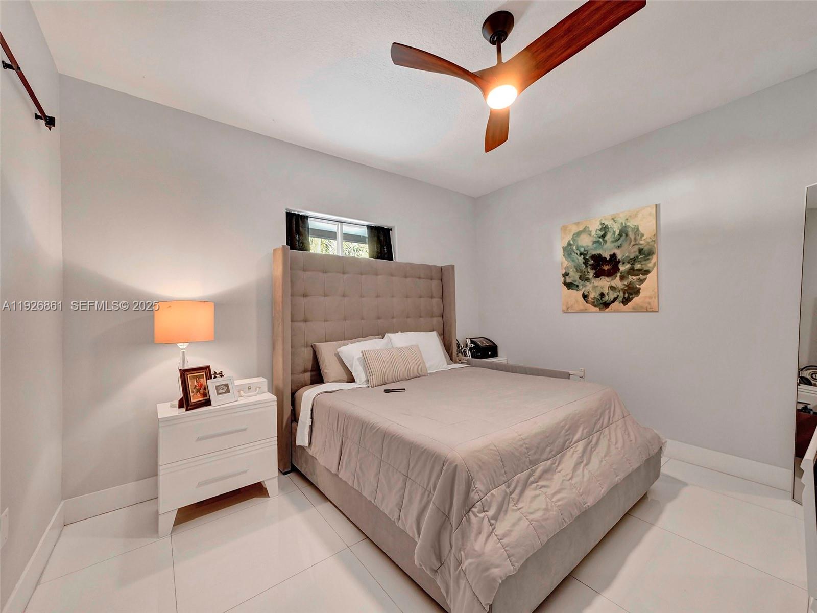 19901 Northwest 77th Court Hialeah, FL 33015 - Photo 27 of 50 a bedroom with a bed and a ceiling fan