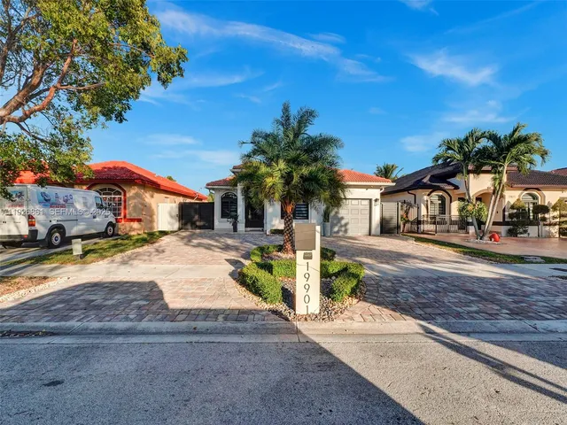 a palm tree sitting in front of a house