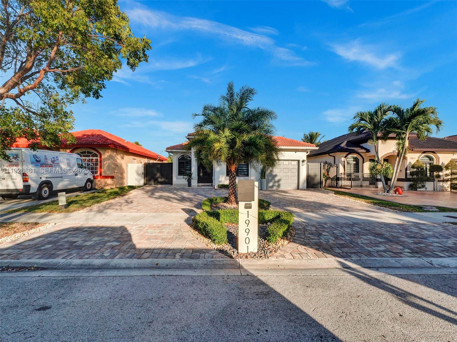 19901 Northwest 77th Court Hialeah, FL 33015 - Photo 3 of 50 a palm tree sitting in front of a house