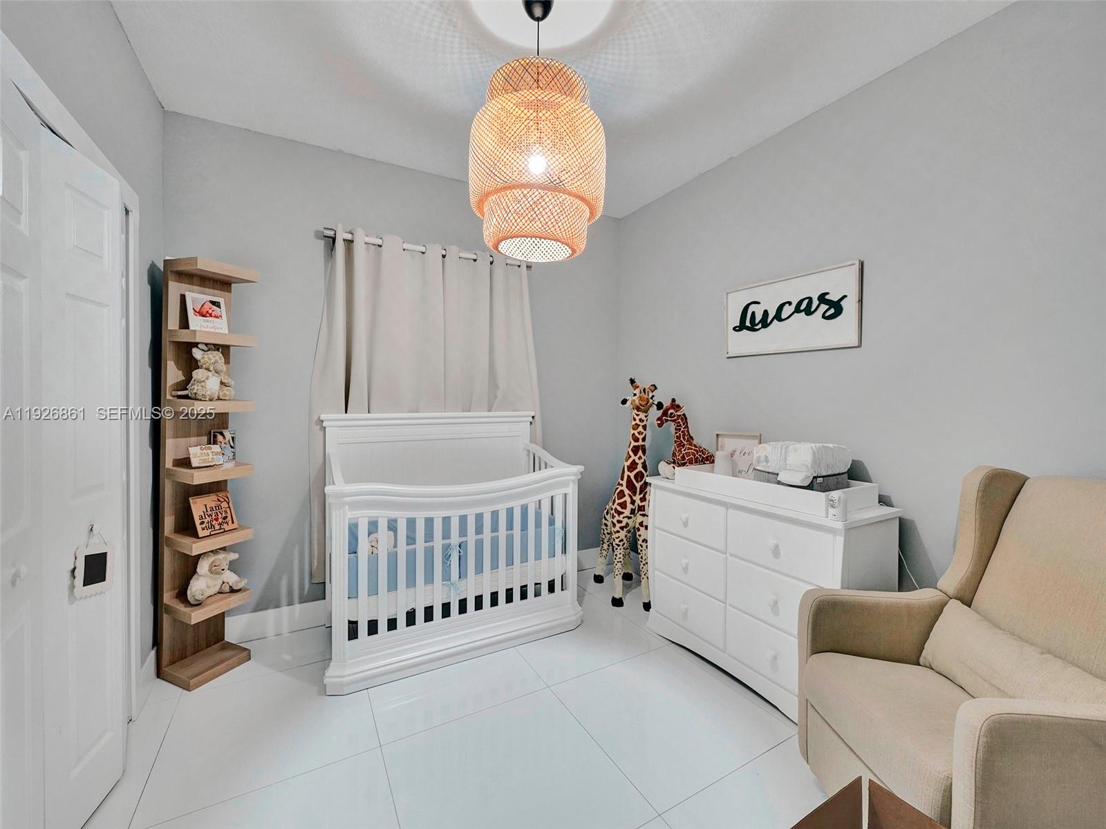 19901 Northwest 77th Court Hialeah, FL 33015 - Photo 34 of 50 a bedroom with furniture and a window