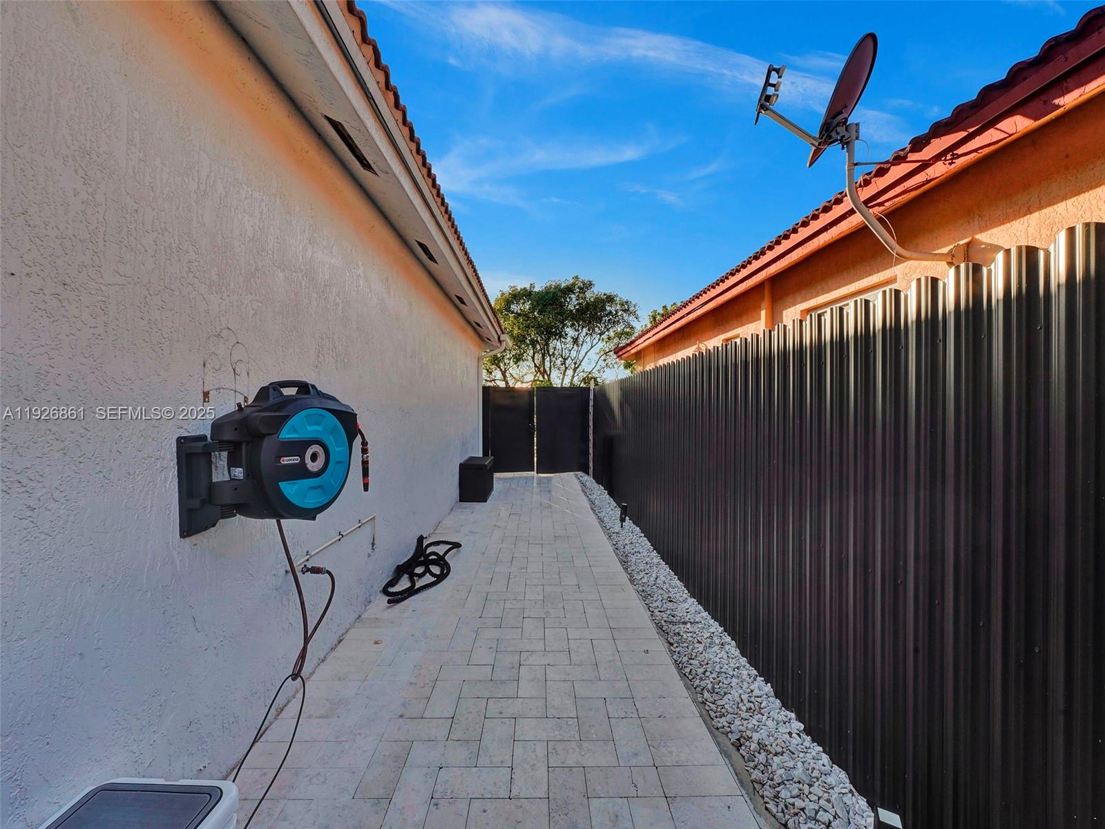19901 Northwest 77th Court Hialeah, FL 33015 - Photo 37 of 50 a backyard of a house with table and chairs