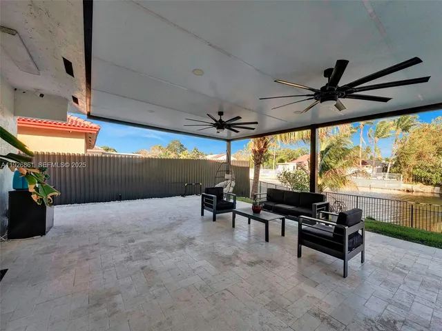 a living room with furniture a air conditioner vent and a window