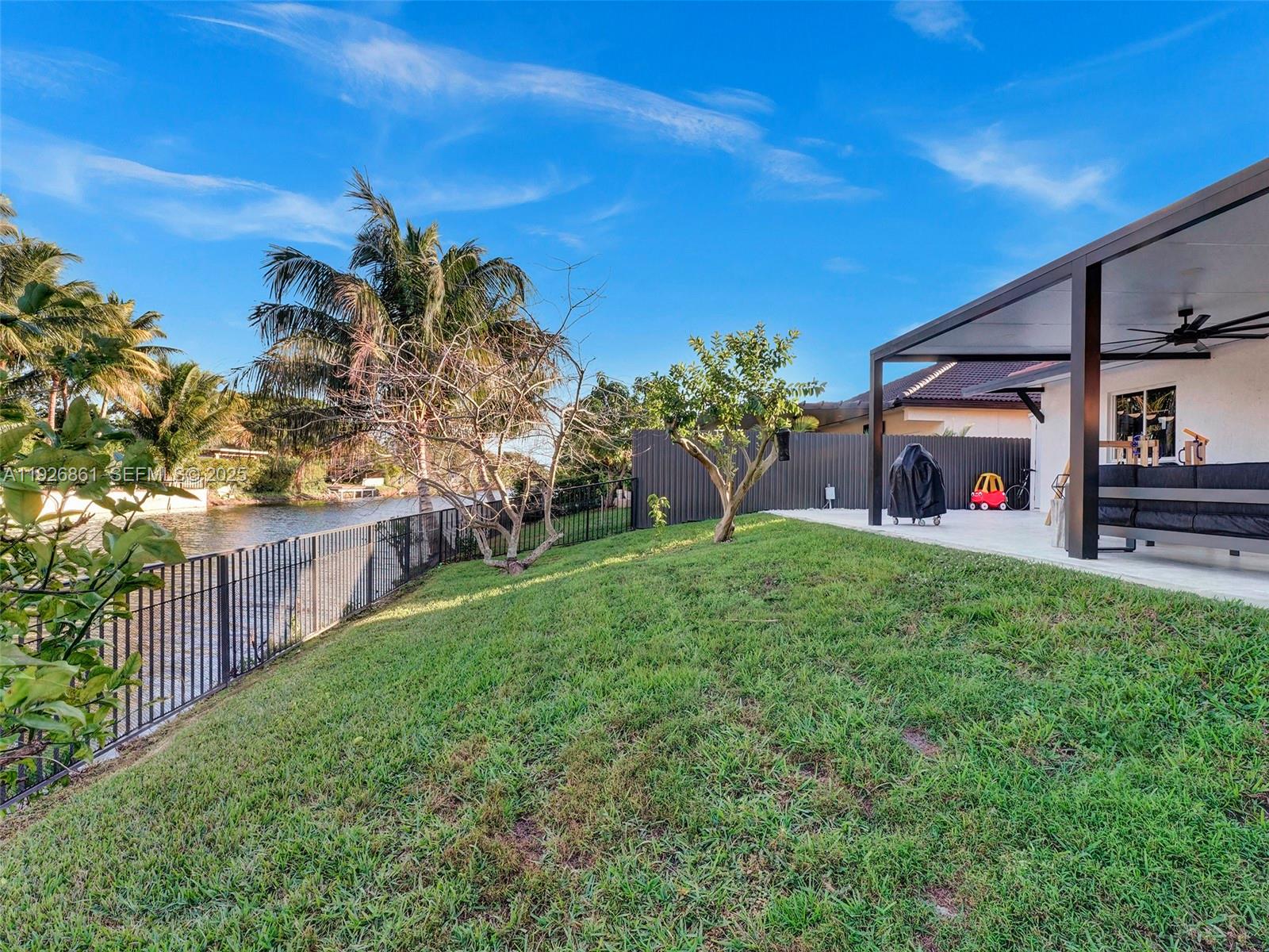 19901 Northwest 77th Court Hialeah, FL 33015 - Photo 47 of 50 a front view of a house with garden