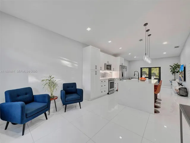 a living room with furniture and a ceiling fan