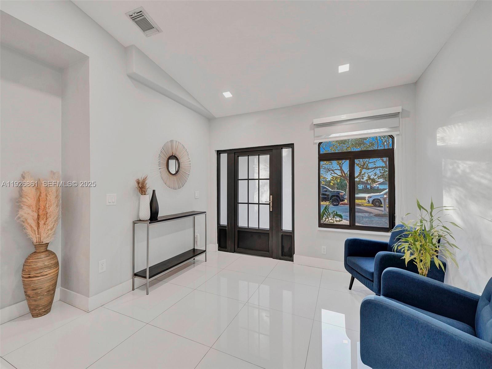 19901 Northwest 77th Court Hialeah, FL 33015 - Photo 7 of 50 a spacious bedroom with a bed and a couch