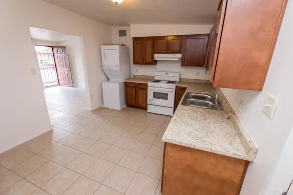 a kitchen with stainless steel appliances a stove a sink and a microwave