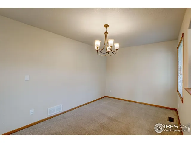 a living room with furniture and a kitchen