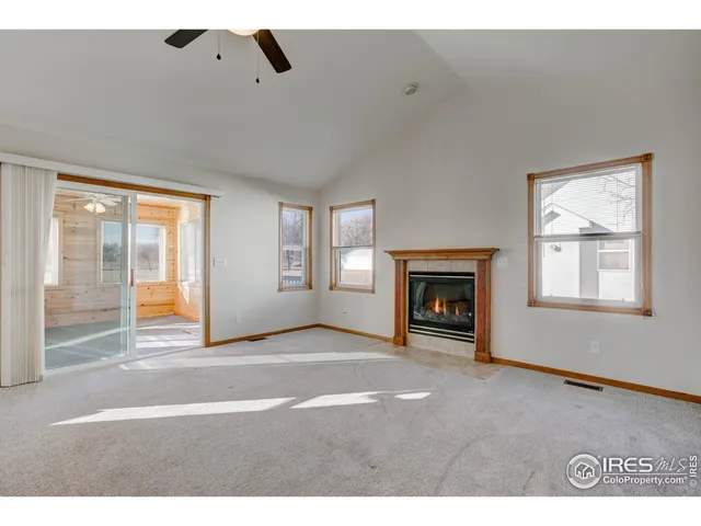 a view of a livingroom with a ceiling fan and window