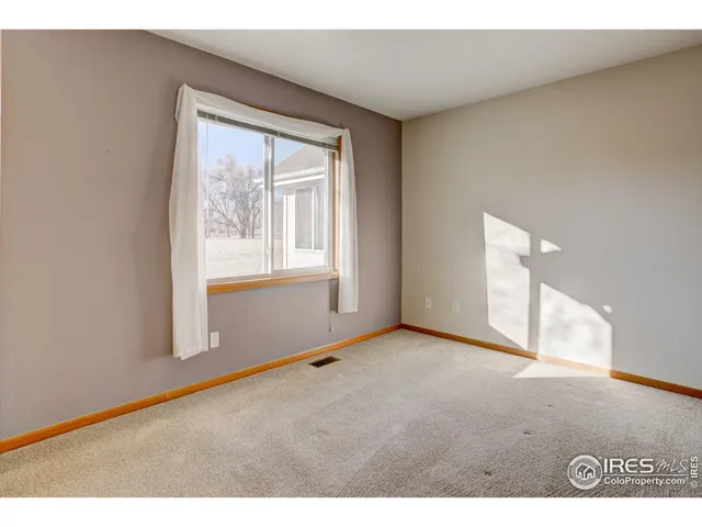 a view of an empty room and fire place