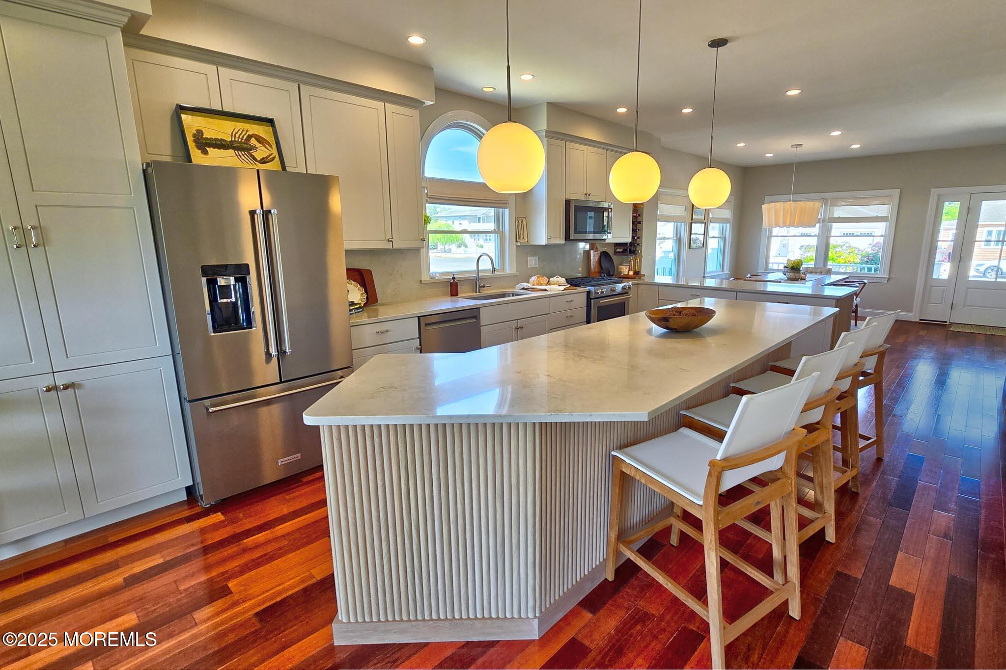 1604 Baltimore Avenue Lavallette, NJ 08735 - Photo 21 of 76 a kitchen with stainless steel appliances granite countertop a refrigerator a stove and a wooden floors