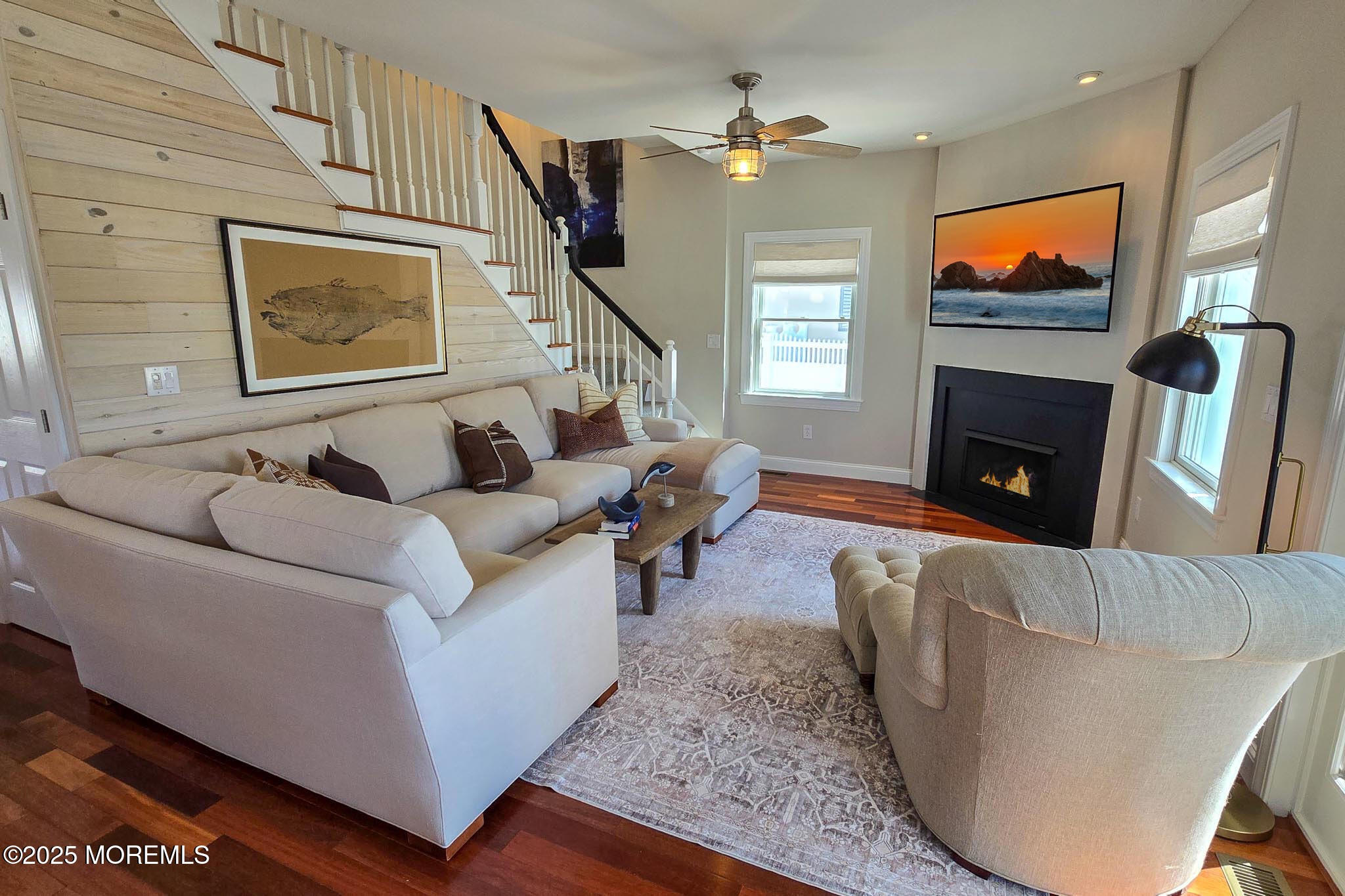 1604 Baltimore Avenue Lavallette, NJ 08735 - Photo 24 of 76 a living room with furniture a fireplace and a flat screen tv