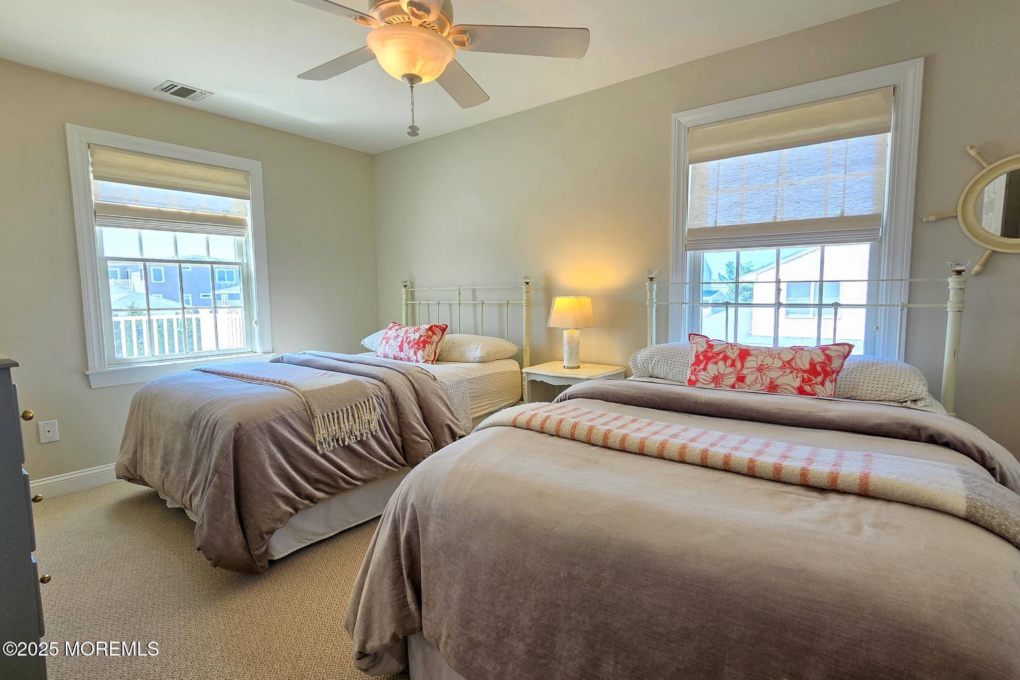 1604 Baltimore Avenue Lavallette, NJ 08735 - Photo 42 of 76 a bedroom with two beds and a chandelier