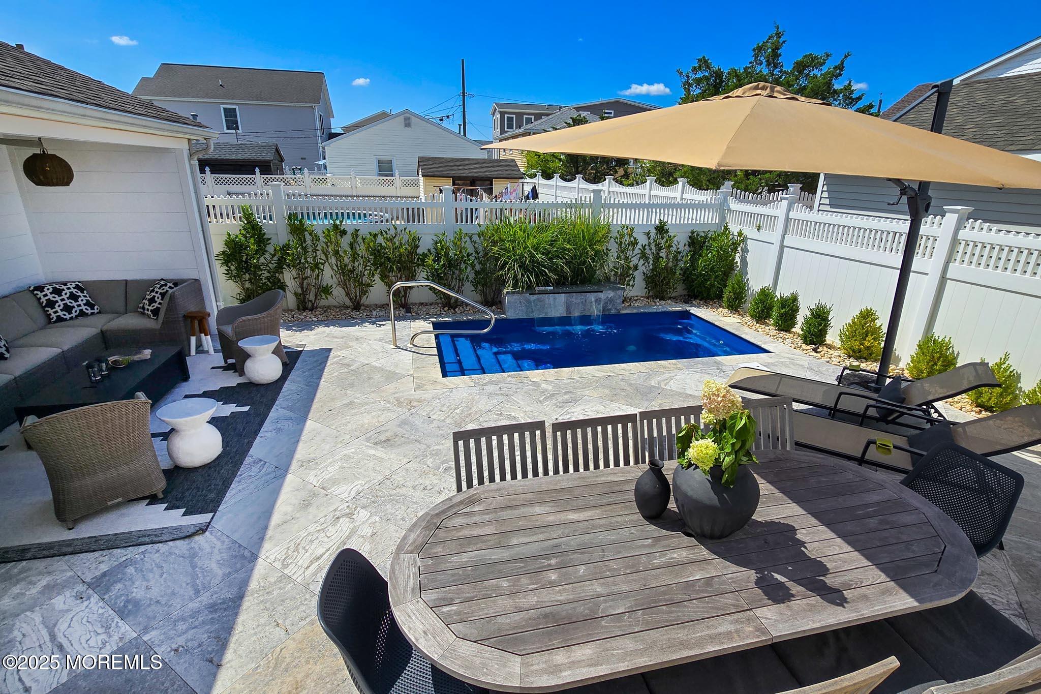 1604 Baltimore Avenue Lavallette, NJ 08735 - Photo 55 of 76 a view of a patio with couches table and chairs under an umbrella