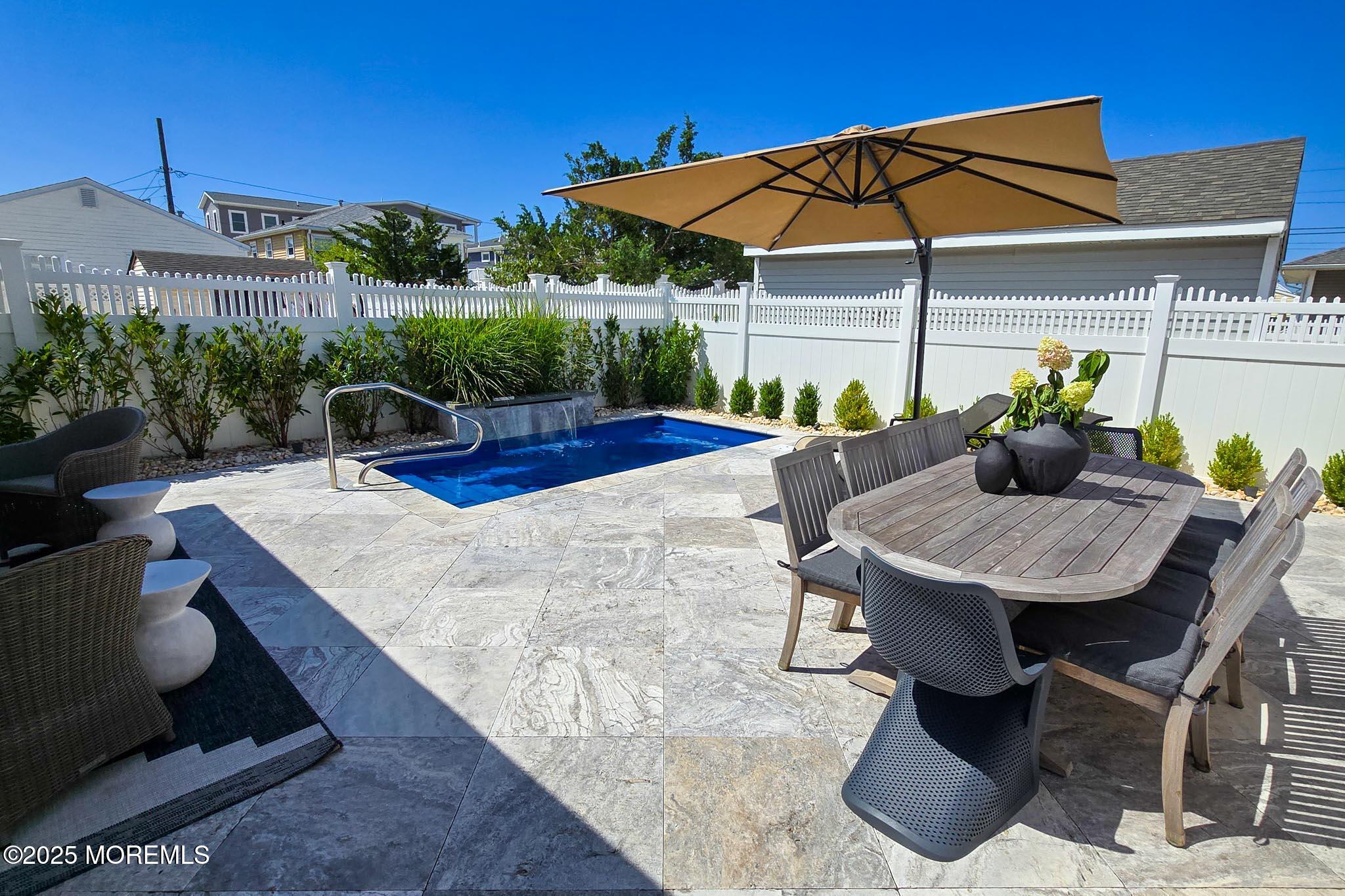 1604 Baltimore Avenue Lavallette, NJ 08735 - Photo 7 of 76 a view of a patio with table and chairs under an umbrella