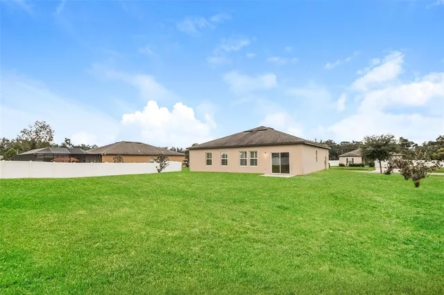 a view of a house with a yard and a garden